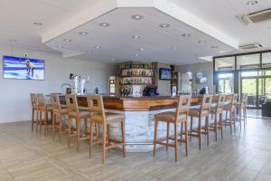 a bar in a restaurant with a bunch of chairs at San Lameer Villa 2818 - 2 Bedroom Classic- 4 pax - San Lameer Rental Agency in Southbroom