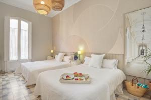 a room with two beds with a tray of food on it at Hostal Poblenou in Barcelona