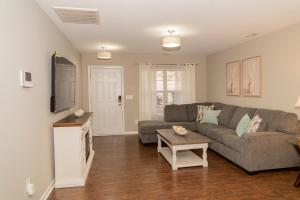 a living room with a couch and a table at Beautiful spacious 4 bedroom house , sleeps 8+ in Raleigh
