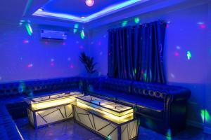 a blue room with a couch and a table at wonderland2 village KTV pool villa in Pattaya North
