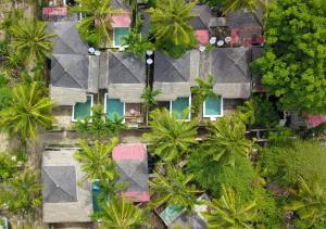 an overhead view of a house with palm trees at Villa Bamboo in Gili Trawangan