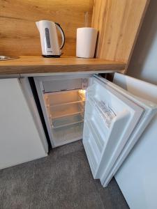 a refrigerator with its door open on a counter at Ru&Ki apartman- Hotel Djina A13 in Kopaonik