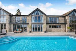 an exterior view of a house with a swimming pool at Poplars Cottage Luxury Detached Home With Outbuildings - Nr Bristol & Bath 