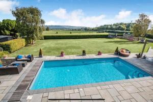 a swimming pool in a yard with a grass field at Poplars Cottage Luxury Detached Home With Outbuildings - Nr Bristol & Bath 