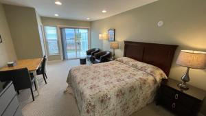 a hotel room with a bed and a desk and a desk at Buena Vista by the Sea in Qualicum Beach