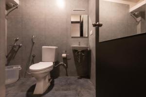 a bathroom with a toilet and a sink at Convastay Prestige- Near Apollo Hospital & US Consulate in Chennai