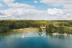 an aerial view of a lake with a dock at seezeit-resort am Werbellinsee in Joachimsthal