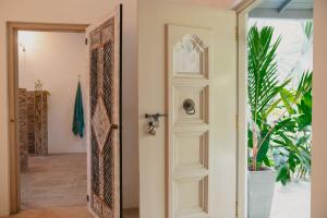 an open door in a room with a plant at Kirinuga Boutique Retreat in Tangalle