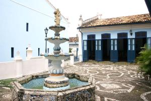 a fountain in front of a building with a fire hydrant at Pousada Barroco na Bahia in Salvador