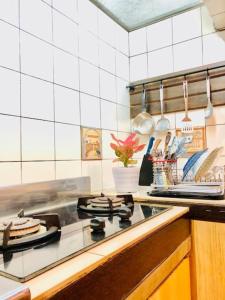 a kitchen with a stove top oven in a kitchen at Citrus-House com Hotel in Bogor