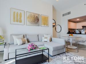 a living room with a couch and a table at KeyOne - 1BR in Sparkle Tower in Dubai