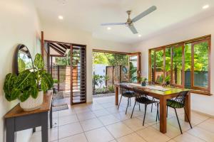 a dining room with a table and chairs at The Savannah Villa in Port Douglas