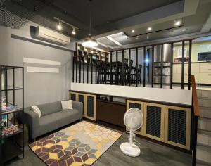 - un salon avec un canapé et un ventilateur dans l'établissement 沐光森野旅宿 永續旅遊, à Wujie
