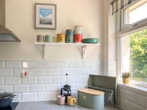 a bathroom with shelves on the wall and a toilet at The Duck House in Wool