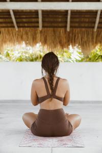 a woman sitting on the floor in a yoga pose at Kirinuga Boutique Retreat in Tangalle