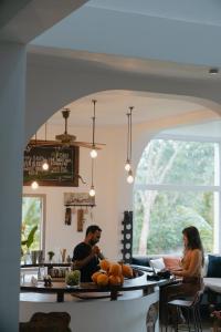 a man and woman sitting at a table in a kitchen at Kirinuga Boutique Retreat in Tangalle