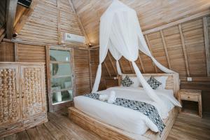 a bedroom with a bed with a mosquito net at Permata Hill Nusa Penida in Nusa Penida +71 photos