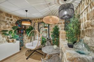 a room with chairs and tables and potted plants at Hotel Berne Opera in Paris