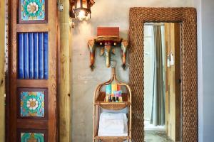 a mirror on a wall next to a door at Fas BnB in Jiali