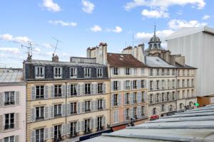 a group of buildings on a city street at Au coeur du triangle d'or de Versailles in Versailles