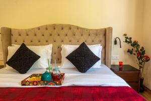 a bed with a tray with two drinks on it at Infinity Villa, 5BHK-Private Pool-Caretaker, Baga in Baga