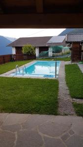 Caines的住宿－Haus Bergwies，一座房子旁的院子内的游泳池