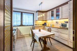 a kitchen with a table and chairs in it at Am Wehrastrand App Eg in Todtmoos