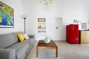 Una sala de estar con un sofá y un refrigerador rojo. en Casina delle Rose - Scirocco, en Polignano a Mare