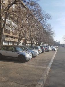 a row of cars parked in a parking lot at Newly equipped Arena apartment in Belgrade