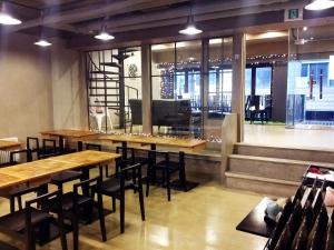 a row of tables and chairs in a restaurant at Petercat Hotel Shinchon in Seoul