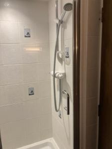 a bathroom with a shower with a shower at Grove House Hotel in Woodbridge