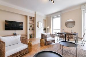 a living room with a couch and a table at Luxury San Babila Apartment in Milan