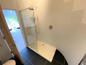 a shower in a bathroom with a glass shower stall at Trewhiddle Villa 30 in St Austell