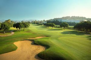 an aerial view of a golf course with a river at Apartamento Playa de la Lucera in La Cala de Mijas