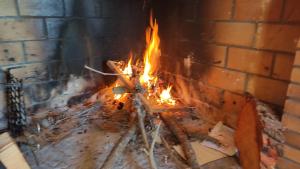 a fire is burning in a brick oven at La casa de l'Avi in Tortellá