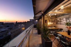 a balcony with tables and chairs on a building at S Hotel Boutique Thessaloniki in Thessaloniki