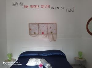 a room with a bed and a sign on the wall at Don Pablo in Lecce