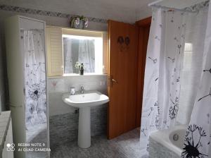 a bathroom with a sink and a shower curtain at Don Pablo in Lecce