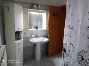 a bathroom with a sink and a window and a shower curtain at Don Pablo in Lecce