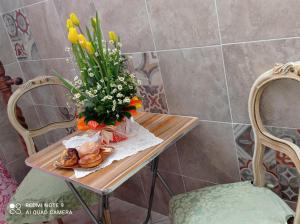 a table with a vase of flowers and croissants at Don Pablo in Lecce