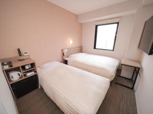 Postel nebo postele na pokoji v ubytování Super Hotel Shonan Fujisawaeki Minamiguchi