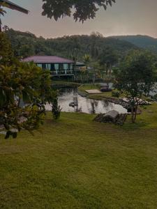 a house with a bridge over a river in a park at Pousada e Restaurante Casa Cida e Evandro in Gaspar