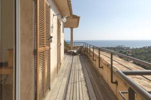 a balcony of a house with a view of the ocean at Les Terrasses de Scalegiu in Porto-Vecchio
