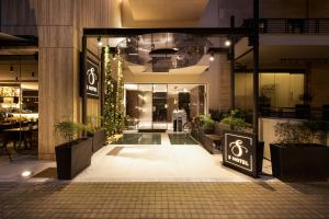 a lobby of a building with plants and lights at S Hotel Boutique Thessaloniki in Thessaloniki