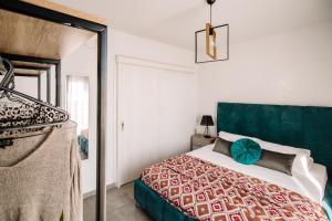 a bedroom with a bed with a green headboard at Miriam's Apartment 2 in Zakynthos Town