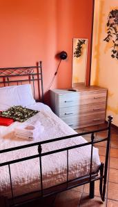 a bedroom with a bed and a dresser and a lamp at La Bicicletta Rifiorita in Ferrara