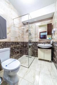 a bathroom with a toilet and a sink at Hotel INTERNATIONAL Ohrid in Ohrid