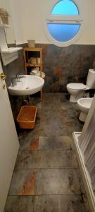 a bathroom with two toilets and a sink at Casa Moki in Uliveto Terme
