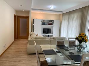 a living room with a couch and a table at Giesta Flower by Madeira Holiday Rentals in Ribeira Brava