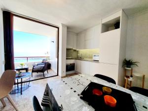 a kitchen and dining room with a view of the ocean at Marina View Apartment in Fuengirola